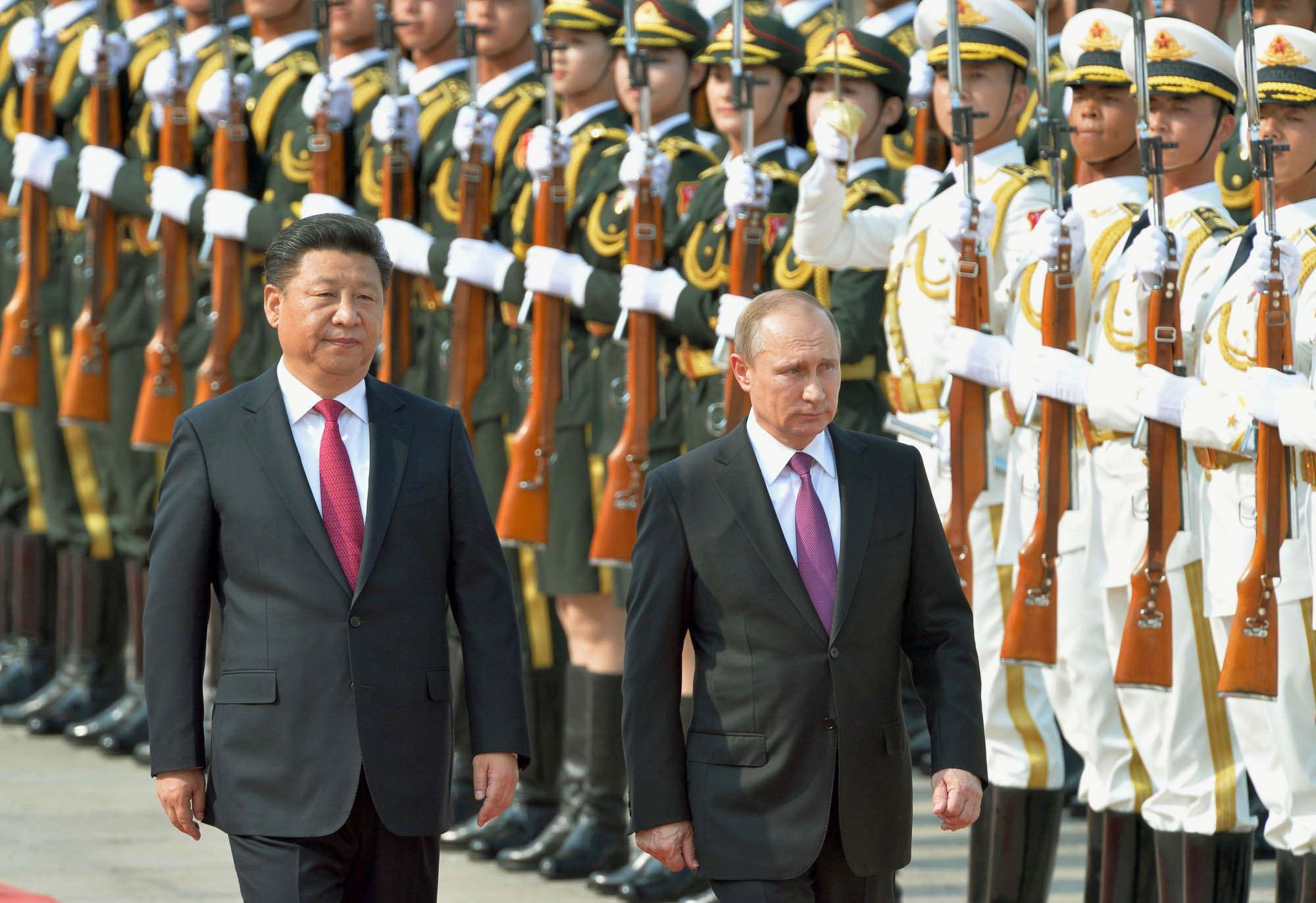 Chinese President Xi Jinping (L) and Russian President Vladimir Putin attend a welcome ceremony for Putin at the Great Hall of the People in Beijing on June 25, 2016. Editorial Credit: Kyodo News Stills via Getty Images.