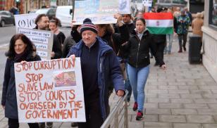Hungarian people living in the English city marched silently through the streets in a show of solidarity with protesters in Hungary. Bristol, England. 16 December 2018. Editorial credit: tviolet / Shutterstock.com