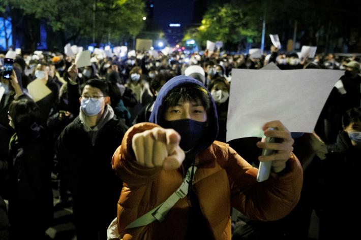 FIW2023_ChinaZeroCOVID People hold white sheets of paper in protest over coronavirus disease (COVID-19) restrictions, after a vigil for the victims of a fire in Urumqi, as outbreaks of COVID-19 continue, in Beijing, China,