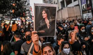 A protester holds a portrait of Mahsa Amini during a demonstration in support of Amini, a young Iranian woman who died after being arrested in Tehran by the Islamic Republic's morality police
