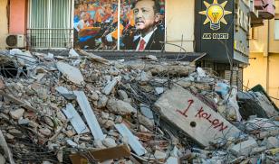 : A photo of Turkey’s President Recep Tayyip Erdogan is seen near the rubble of a collapsed building after a massive earthquake devastated the southern region of the country.