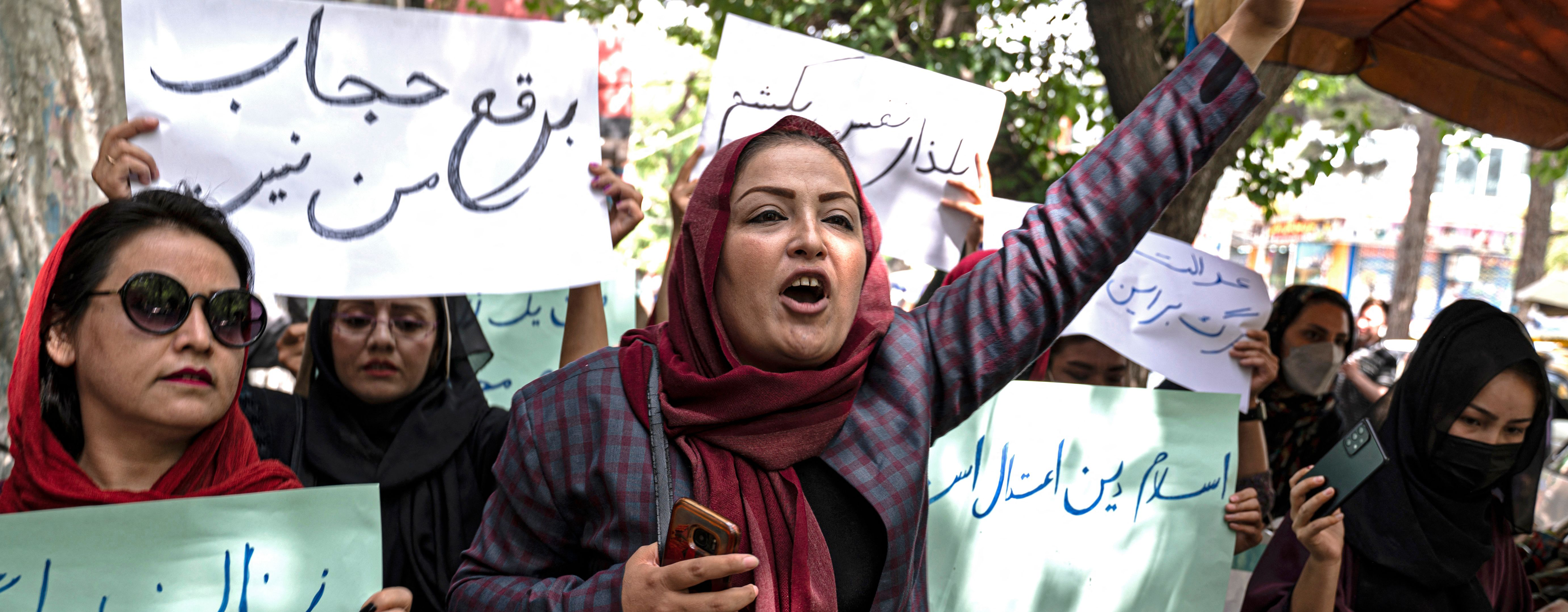 Members of Afghanistan's Powerful Women Movement, take part in a protest in Kabul on May 10, 2022. - About a dozen women chanting "burqa is not my hijab" protested in the Afghan capital on May 10 against the Taliban's order for women to cover fully in public, including their faces.